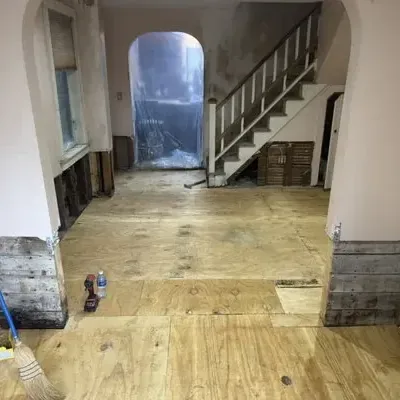 A hallway with flood-cut walls and the subfloor exposed during a dry-out
